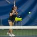 Diya Malhotra of Pioneer girls tennis team retunes the ball  during practice Thursday night.
Courtney Sacco I AnnArbor.com 